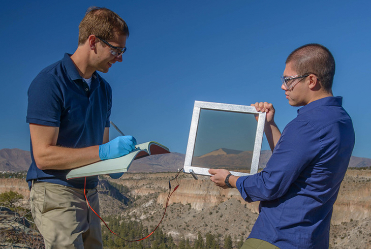 team members measure the electrical output of a window prototype