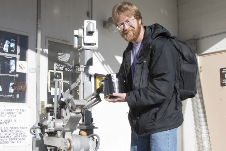 scientist pictured with Gamma Lightthouse Detector on a robot