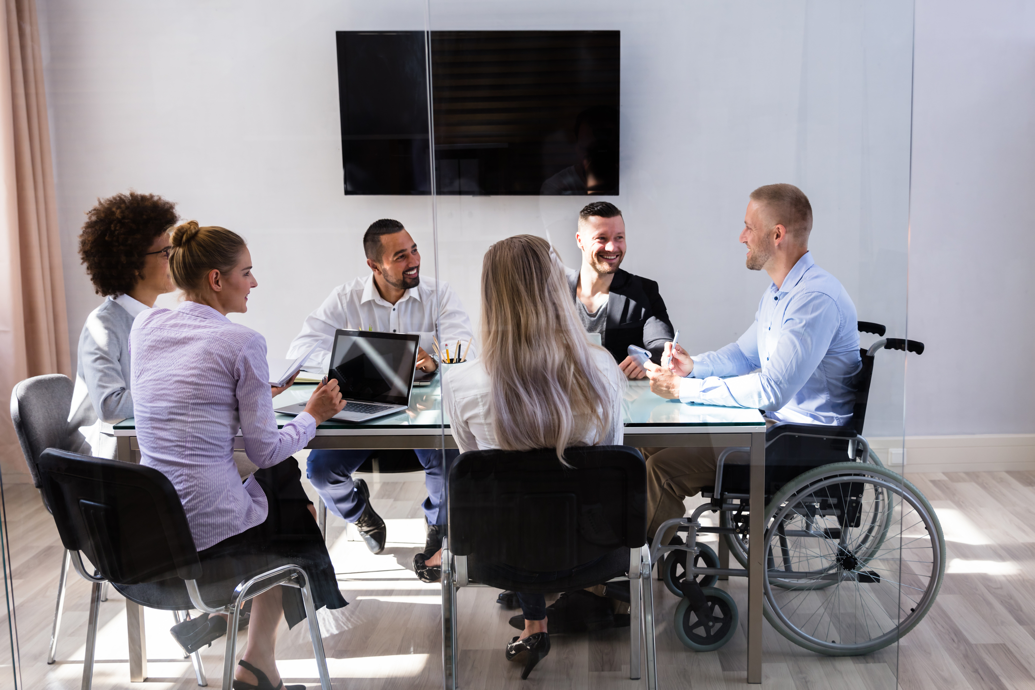 Team picture of a diversity of workers, headed by manager in a wheelchair. Photo 181429353 © Andrey Popov | Dreamstime.com