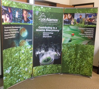Photo. Booth banner at the conference focuses on LANL research.