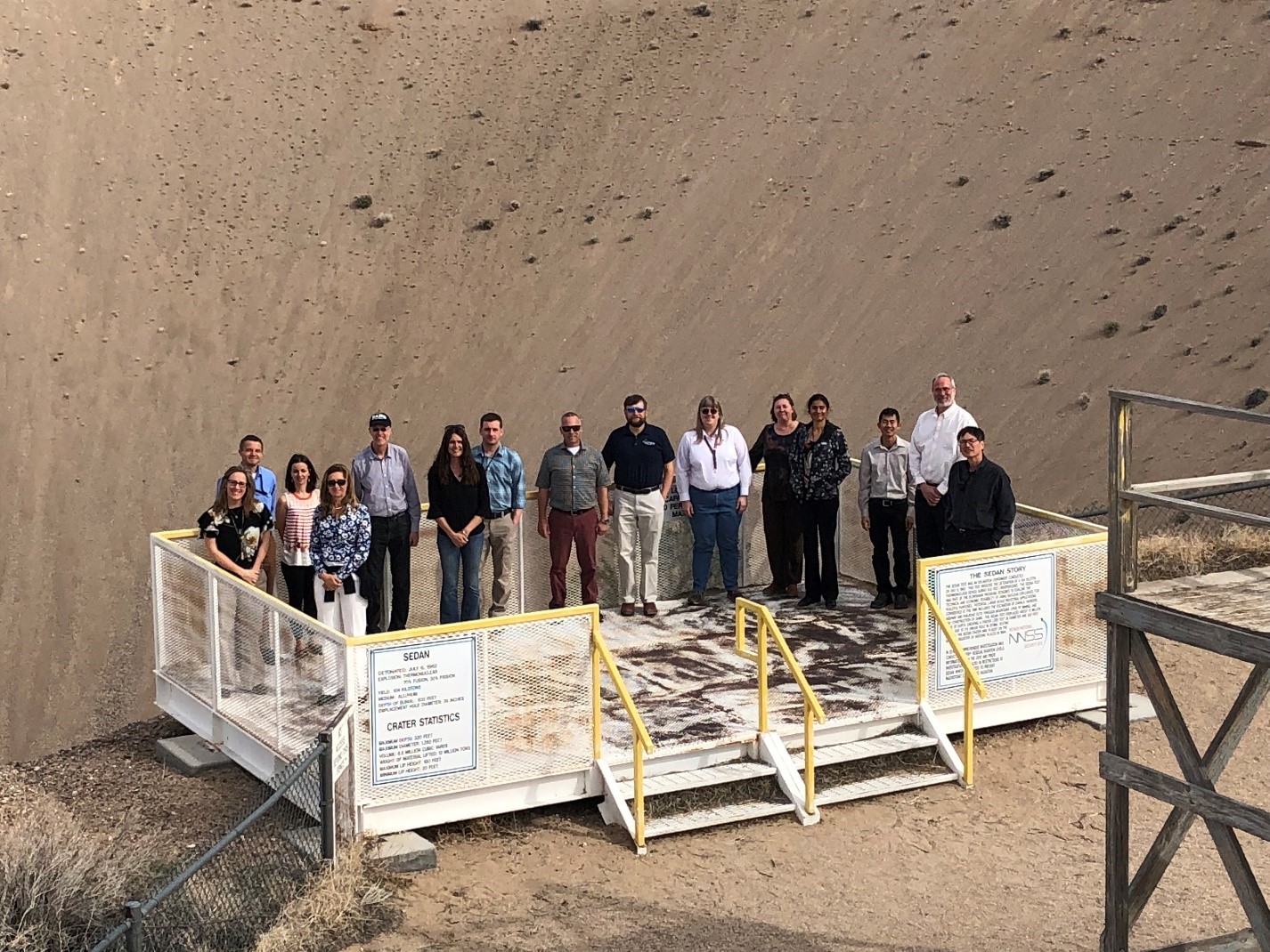 LANL managers visit the Sedan Crater, formed as a result of the Sedan nuclear test conducted in July 1962. Left to right: Stacy Mclaughlin, AMPP-DO; Alexei Klimenko, ISR-1; Suzanne Nowicki, ISR-1; Stephanie Archuleta, DESH-DO; Mark Chadwick, ALDX; Kim Obrey, MST-8; Cory Johnson, A-3; Charles Kelsey, P-27; Jeff Pietryga, C-IIAC; Morag Smith, NEN-3; Michelle Silva, NEN-3; Gowri Srinivasan, XCP-8; Jimmy Fung, XCP-1; Pat Fitch, ALDCELS; and Michael Cai, ISR-DO.
