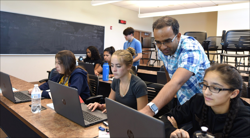 Ramesh Jha (B-11), standing on right, helps students analyze data at the JSTI–ABQ workshop this summer.