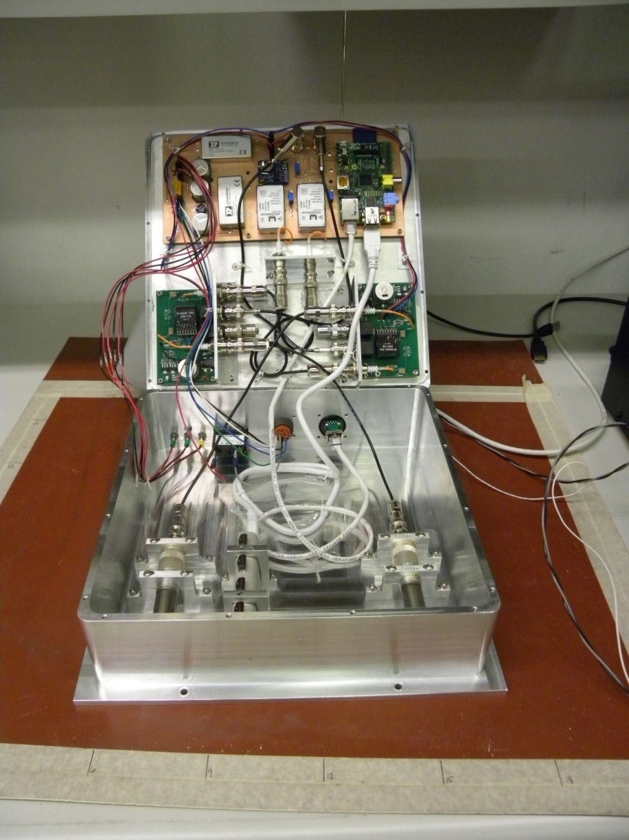 Inside the Tinman detector, the bottom contains the two He-3 tubes and the lid contains the signal processing electronics, the power supplies, and the Raspberry Pi computer.