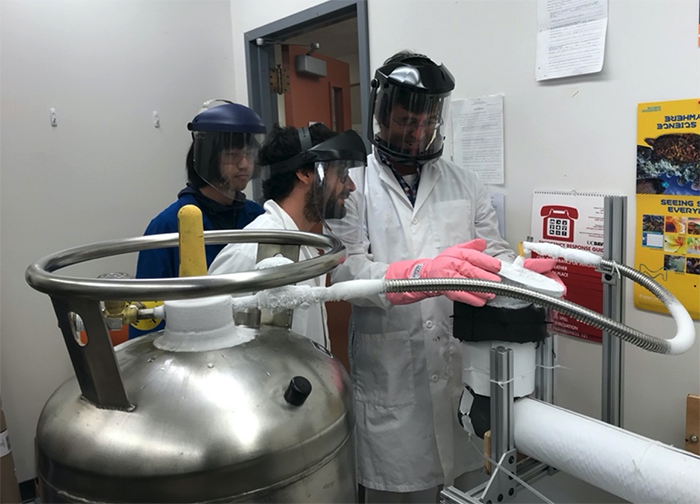 From left:  Junying Huang, Luca Pagani, and Mike Mulhearn test the cryogenic ARTIE target performance at UC Davis.